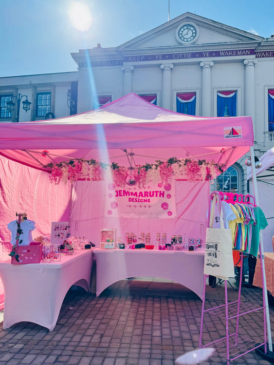 Photo of a JemmaRuth Designs Pink Artisan Market Stall, showing various items that are also for sale on the website
