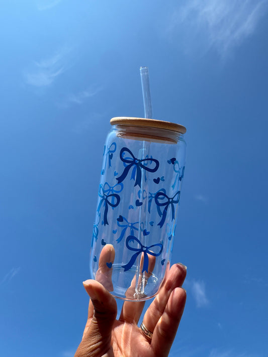 “Handmade clear glass decorated with a blue bow and heart design by JemmaRuth Designs, UK small business creating unique glassware and drinkware.”