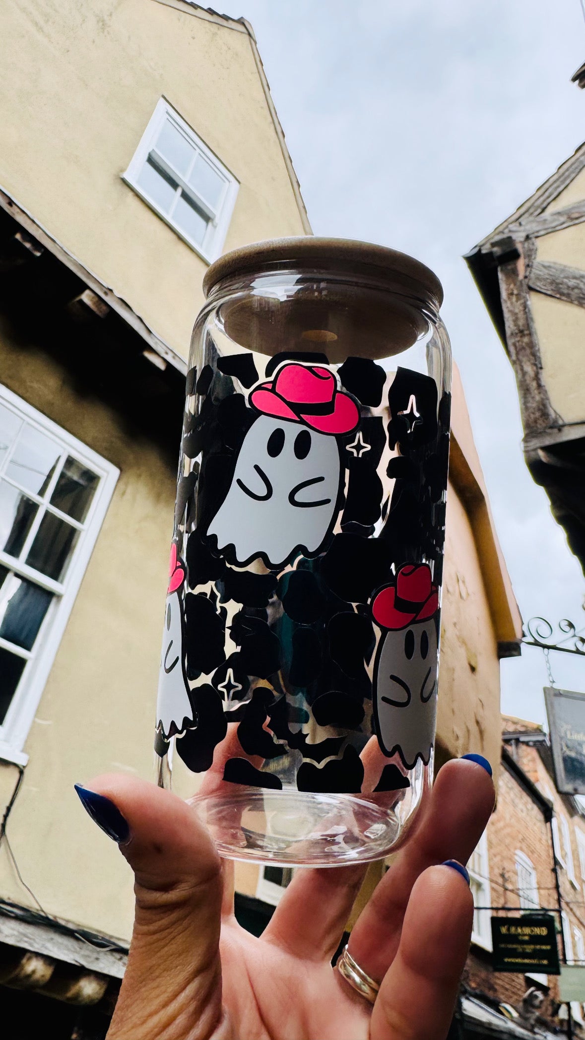 Close-up of glowing pink cowboy hat detail on ghost design glass can cup
