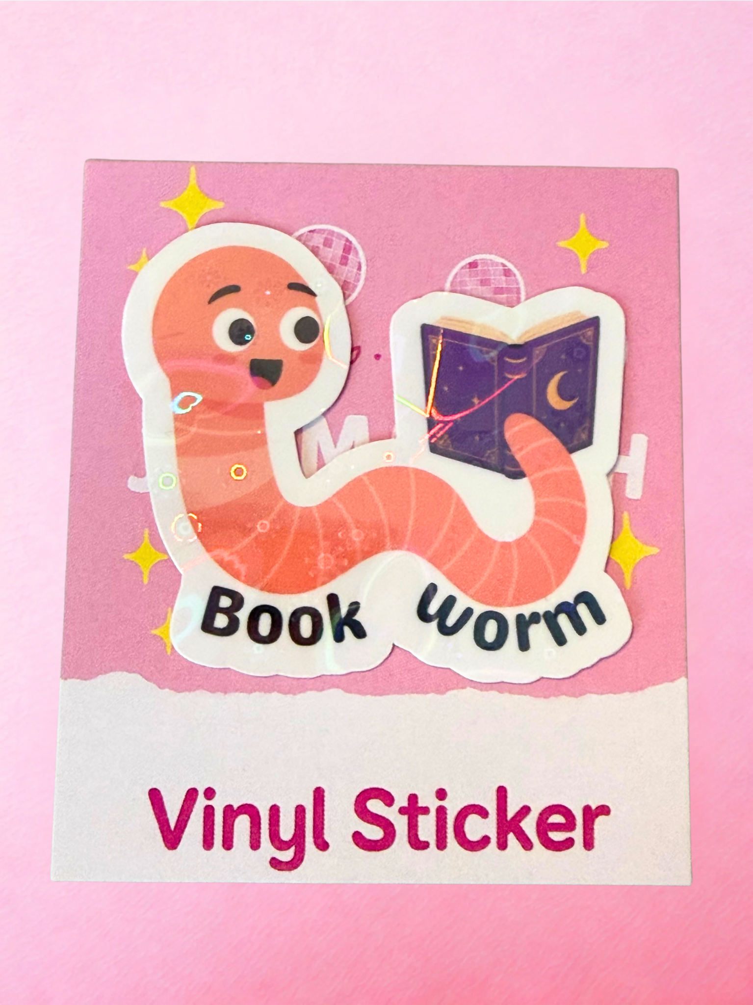 Cute book worm vinyl sticker with reading worm character holding a purple fantasy book