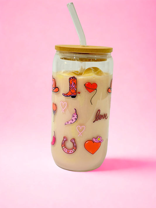 16oz country girl Valentine glass can cup with bamboo lid and glass straw, pink hearts and country-inspired icons on a pink background.”