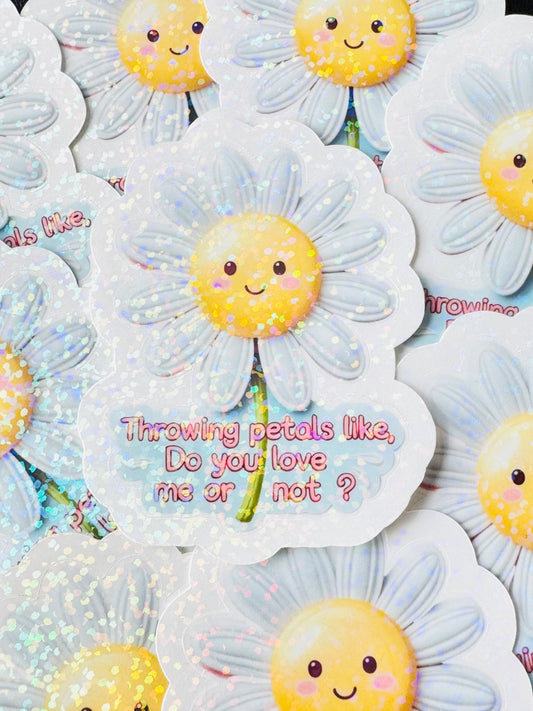 Cute waterproof vinyl sticker of a smiling daisy tossing petals with the quote “Throwing petals like, do you love me or not” – inspired by Justin Bieber’s Daisies song. Glossy overlay finish.
