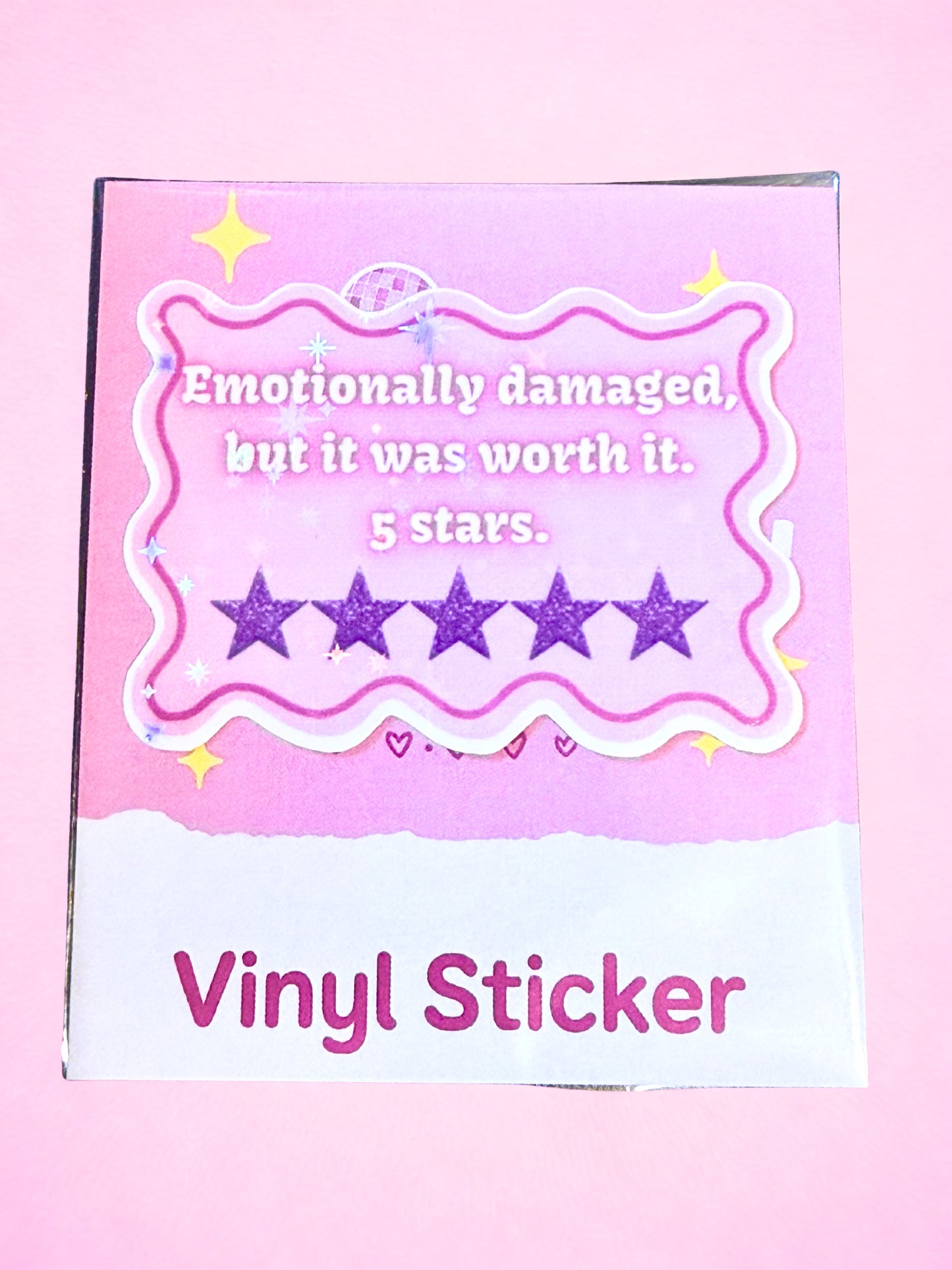Pink Emotionally Damaged but it was worth it 5 stars vinyl sticker with purple glitter stars and glossy laminate finish.