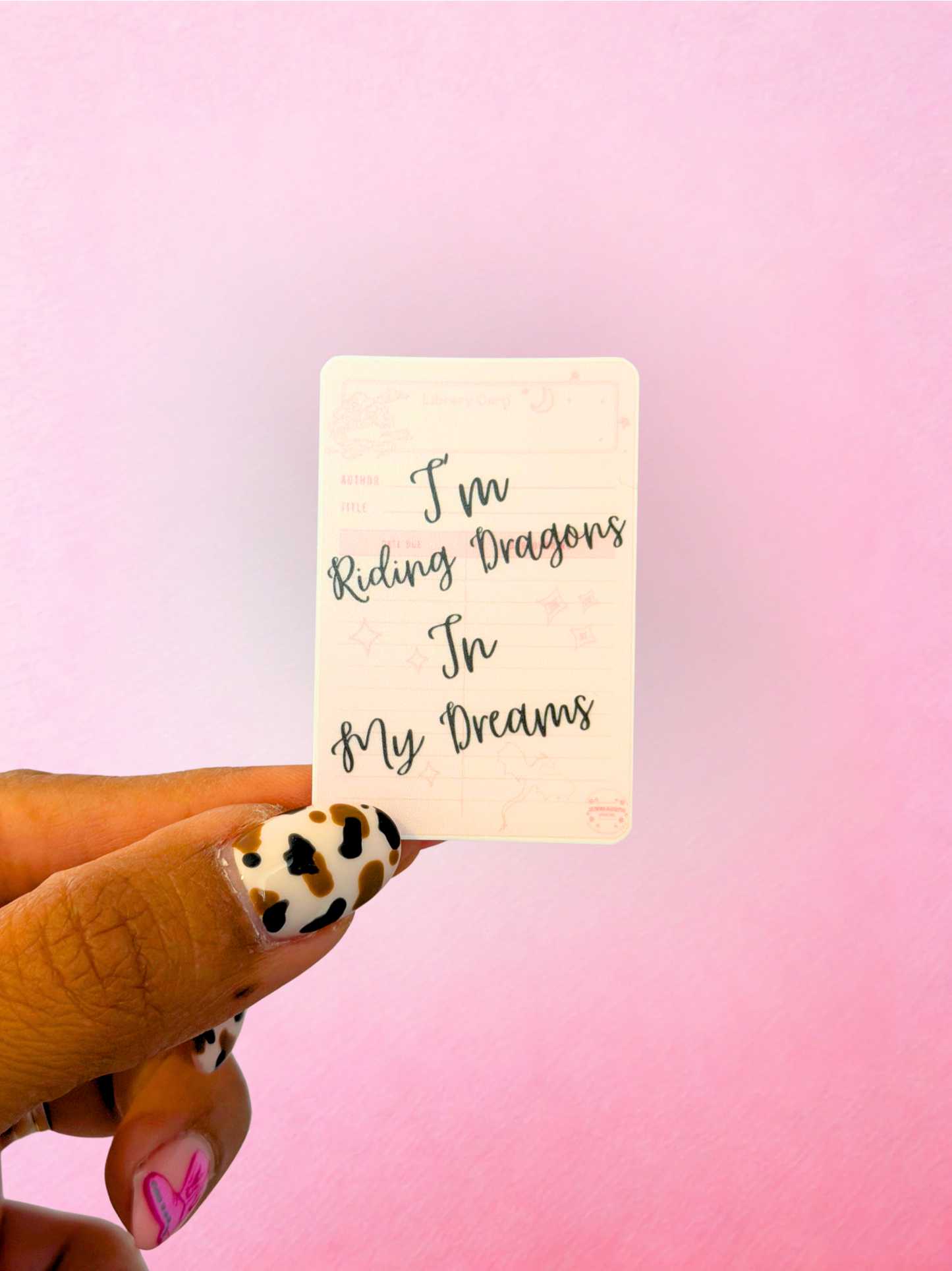 Pink fantasy dragon vinyl sticker with reading quote for romantasy readers and book lovers