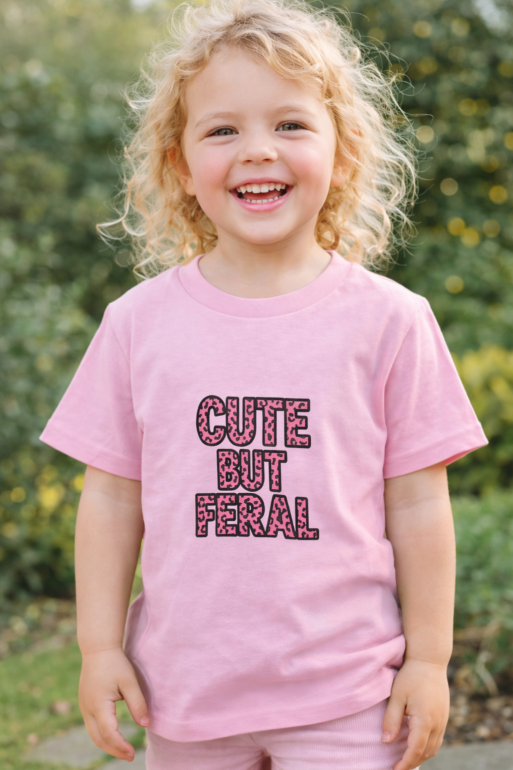 Cute But Feral kids t-shirt in pink with pink leopard print text