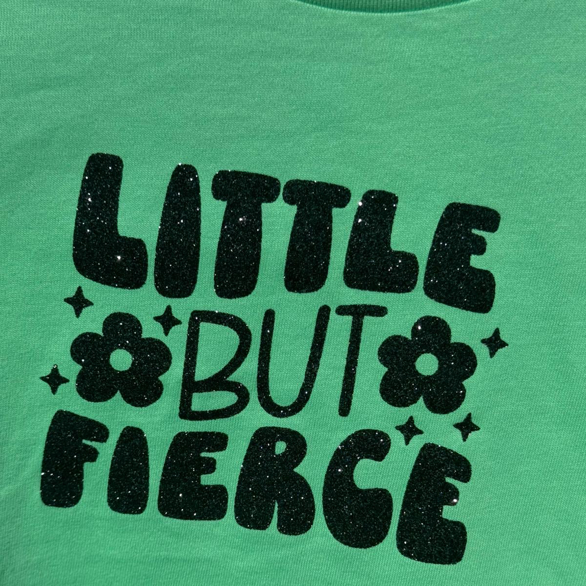 Green t-shirt with 'Little But Fierce' wording in Black the wording has a beautiful shimmery finish. 