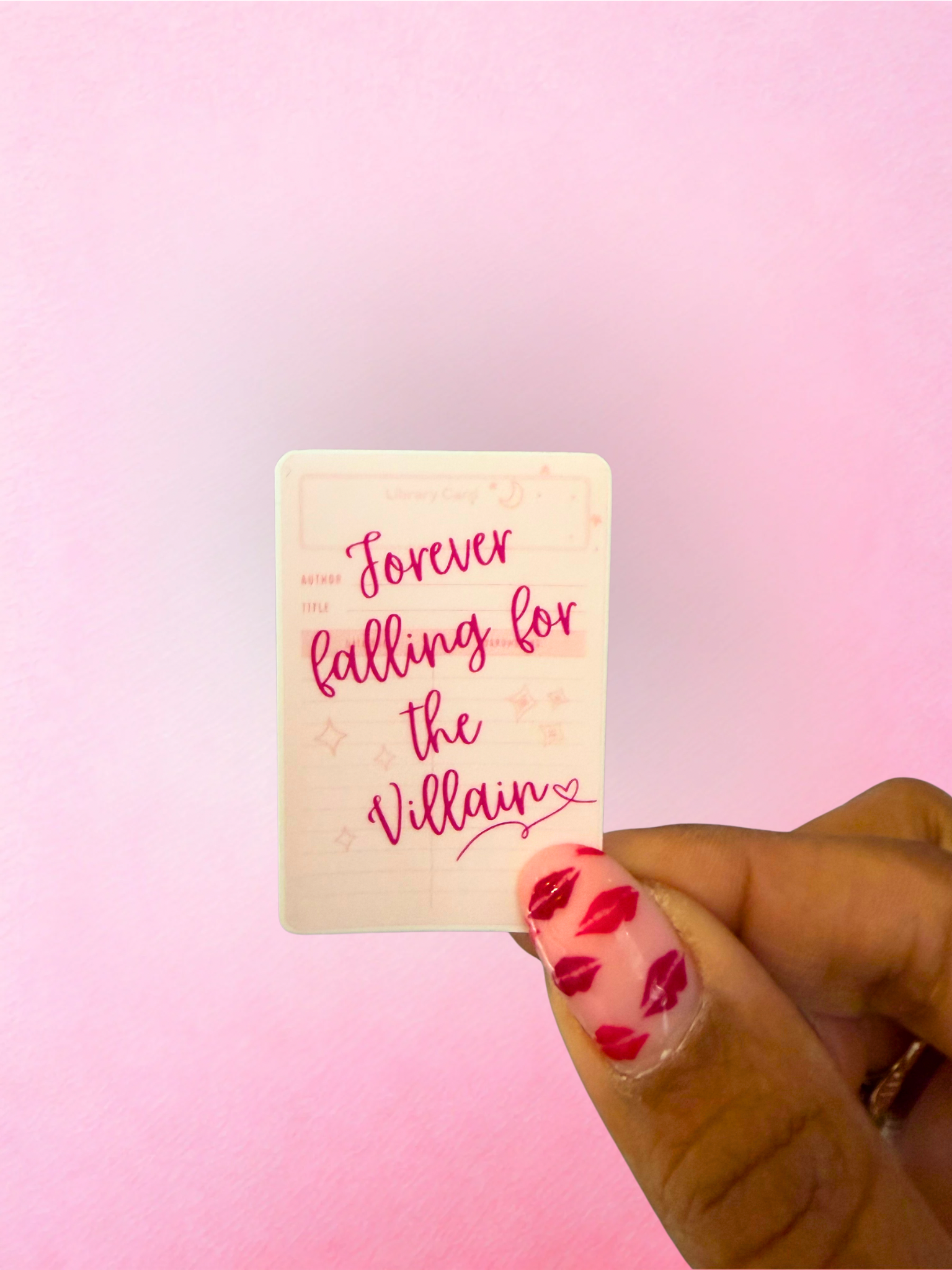 Pink falling for the villain vinyl sticker with library card design for romantasy readers and book lovers