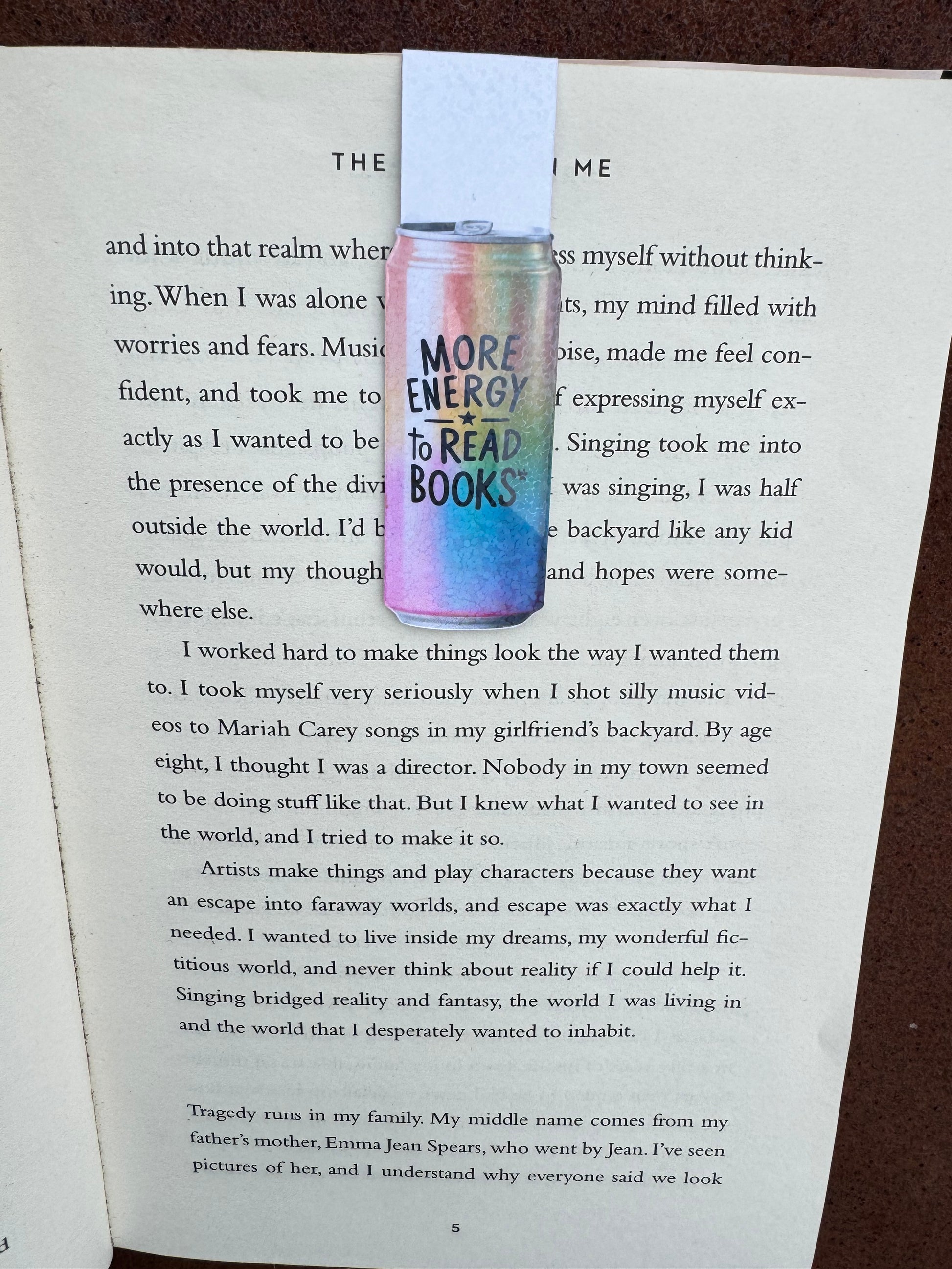 energy drink style can magnetic bookmark with rainbow colours black font saying more energy to read books magnetised to a book