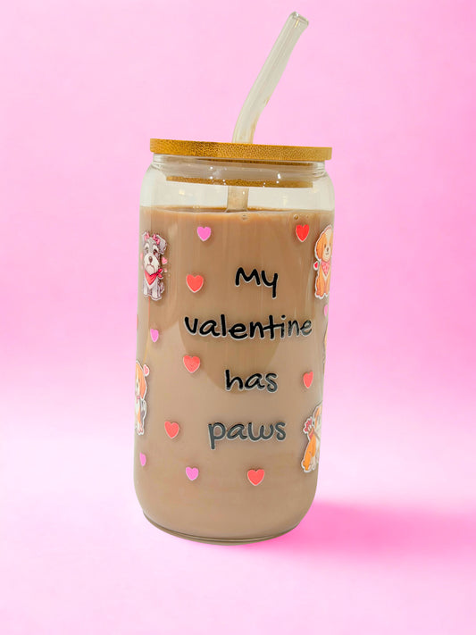 “16oz My Valentine Has Paws glass can cup with bamboo lid and glass straw, dog illustrations and heart design on a pink background.”