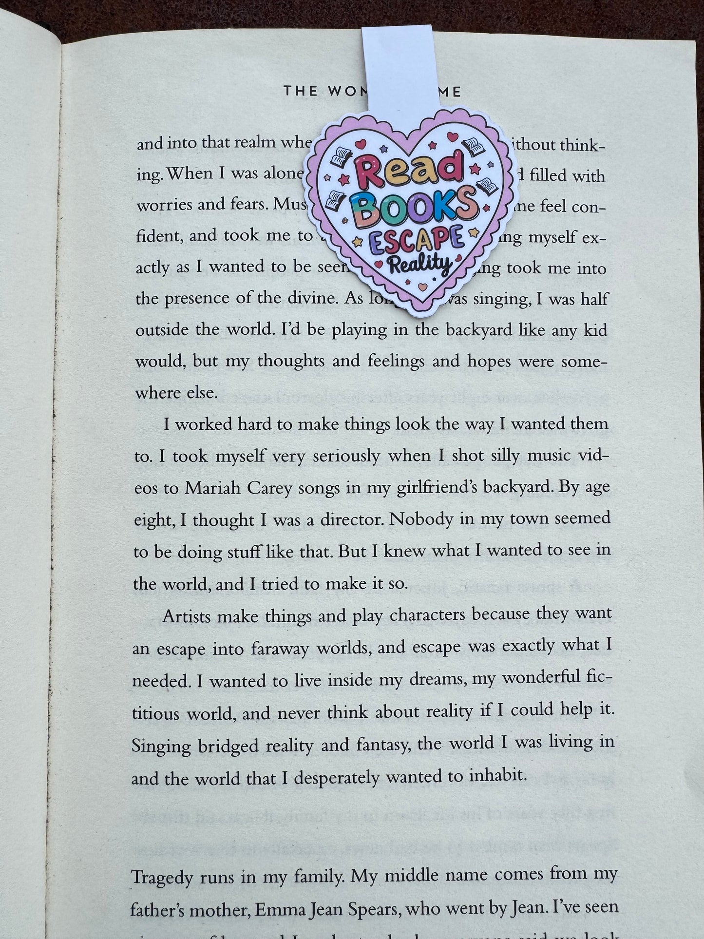 Love heart design stuck to the page by magnetic force inside the heart it says read books escape reality
