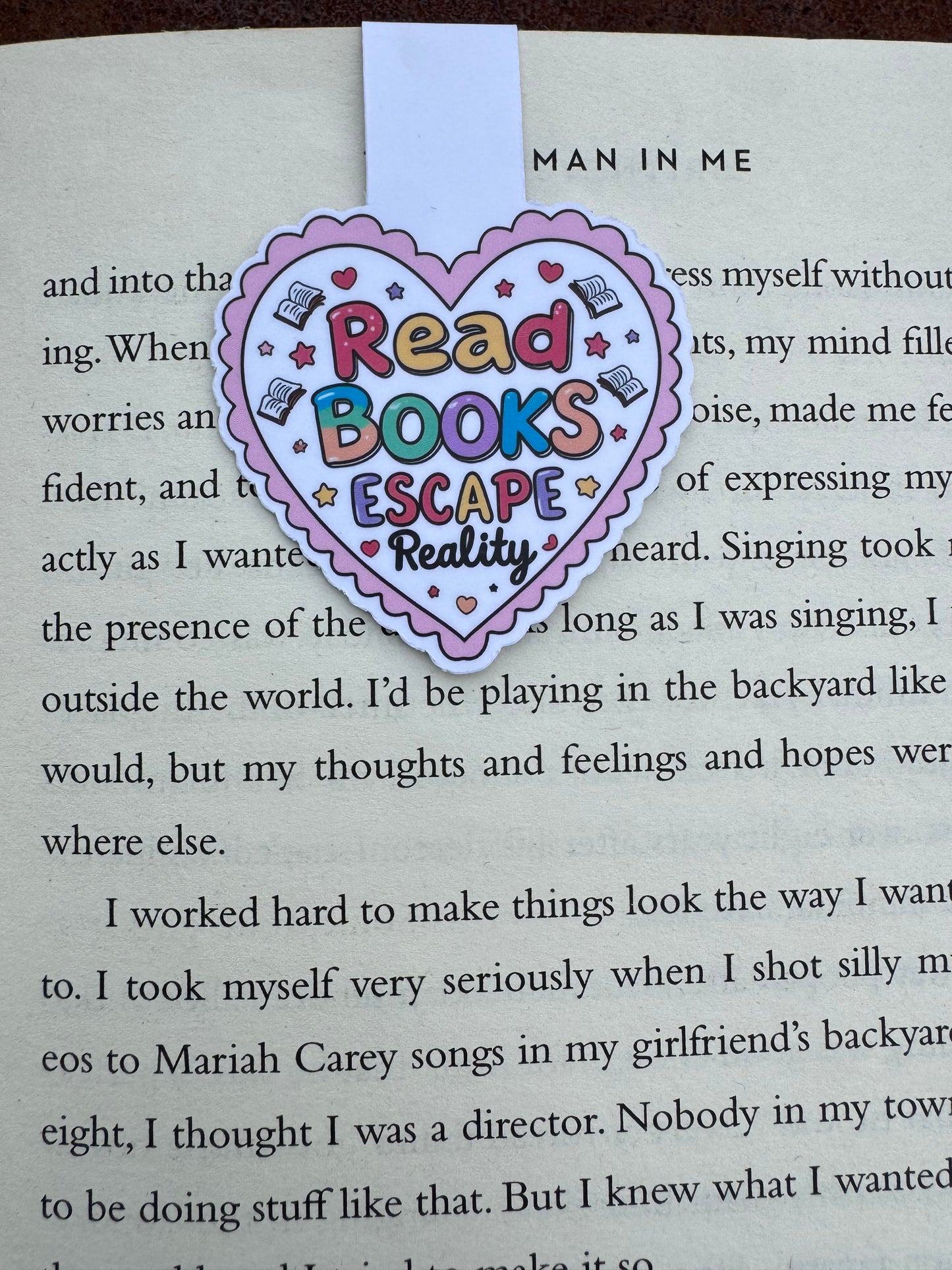Love heart design stuck to the page by magnetic force inside the heart it says read books escape reality close up