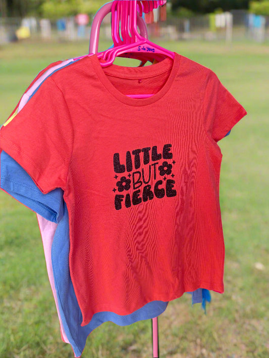 Red kids' T-shirt with the text 'LITTLE BUT FIERCE' printed in black.