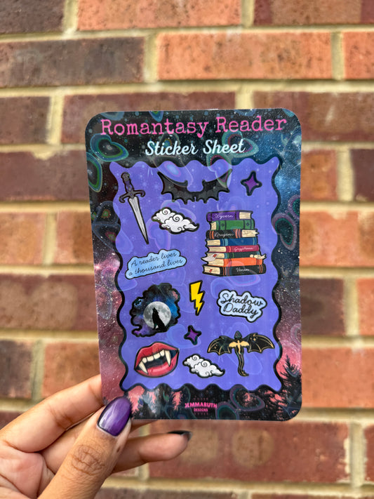 Romantasy Reader sticker sheet featuring 13 fantasy-inspired stickers including books, a sword, bats, dragon, moon, vampire fangs, lightning bolt and bookish quote on a purple galaxy background