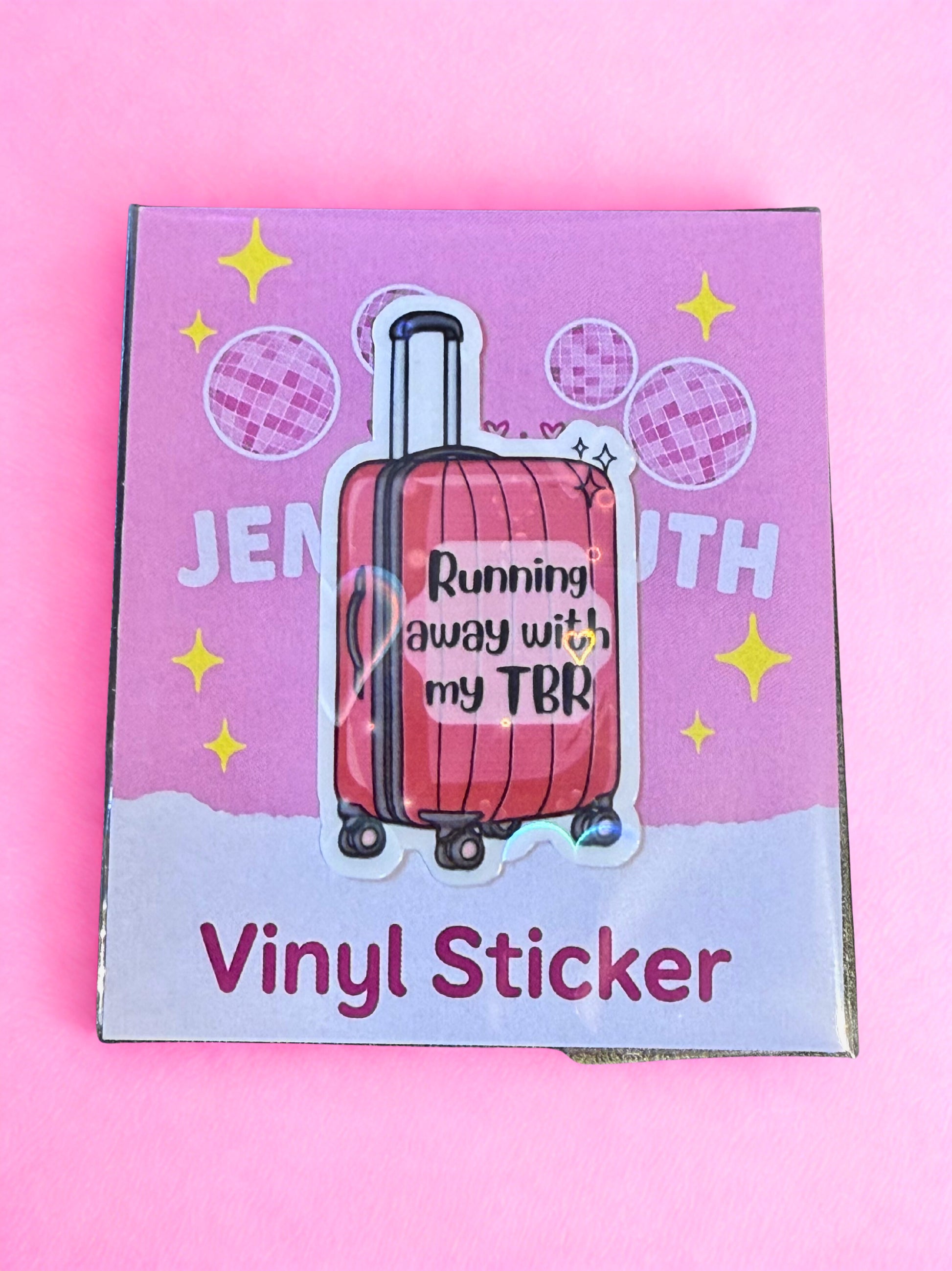 Pink suitcase Running Away With My TBR vinyl sticker with glossy laminate and holographic detail.