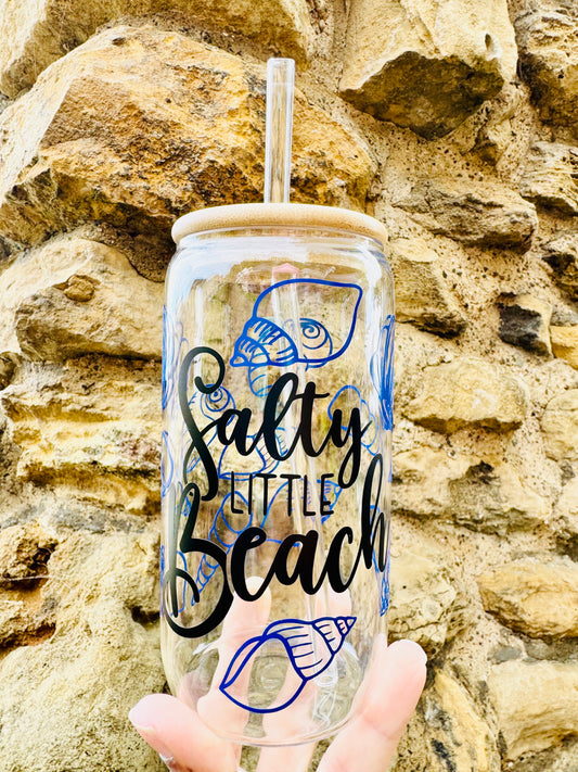 Glass Can Cup with salty little beach printed in a cursive black font with blue sea shells all around the glass