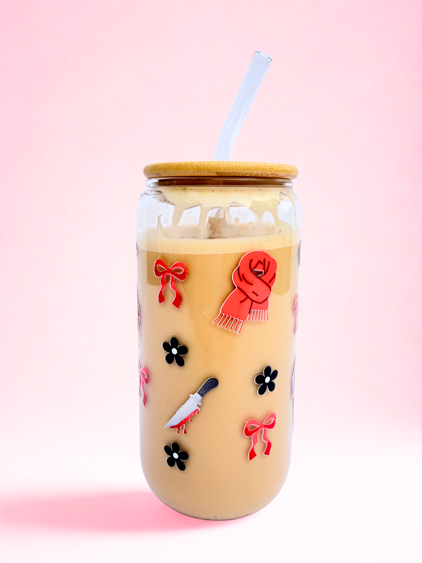 A 16oz glass with a bamboo lid and glass straw, featuring red bows, black flowers, and a “Crime and Thriller” design on a pink background. Matching bookmark sold separately.