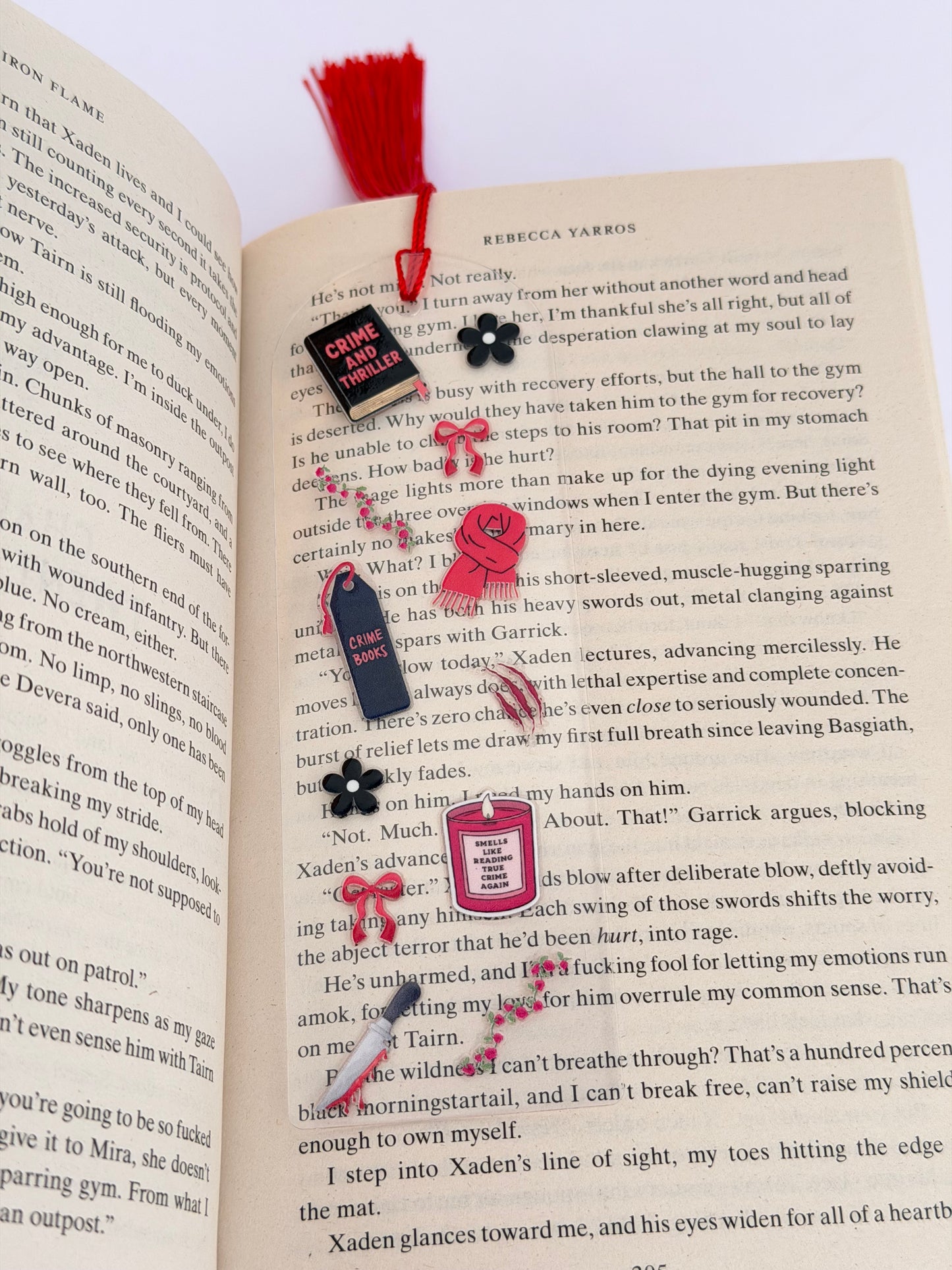 Close-up of The Thriller Bookclub Acrylic Bookmark showing bookish icons and text such as “Smells Like Reading This One Again” and “Crime and Thriller,” placed across an open page.