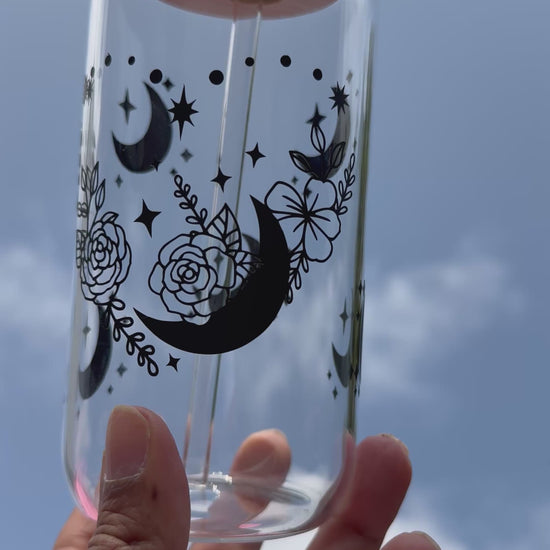 Video shows Moon and roses heart design glass can cup with bamboo lid and reusable glass straw, decorated with moons and stars, 16oz / 480ml.
