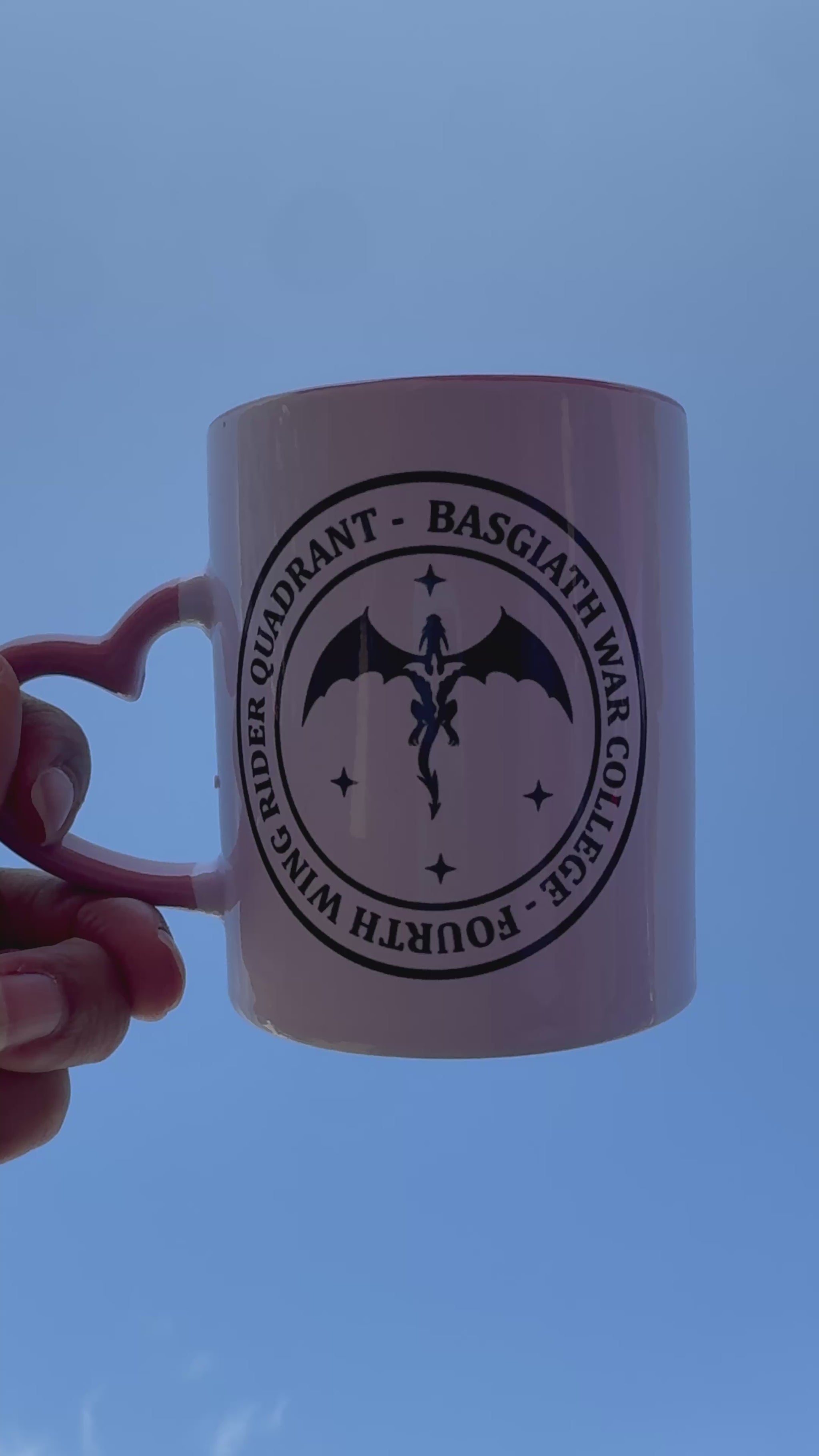 White fantasy mug with pink handle featuring Basgiath War College text and dragon emblem, inspired by Fourth Wing